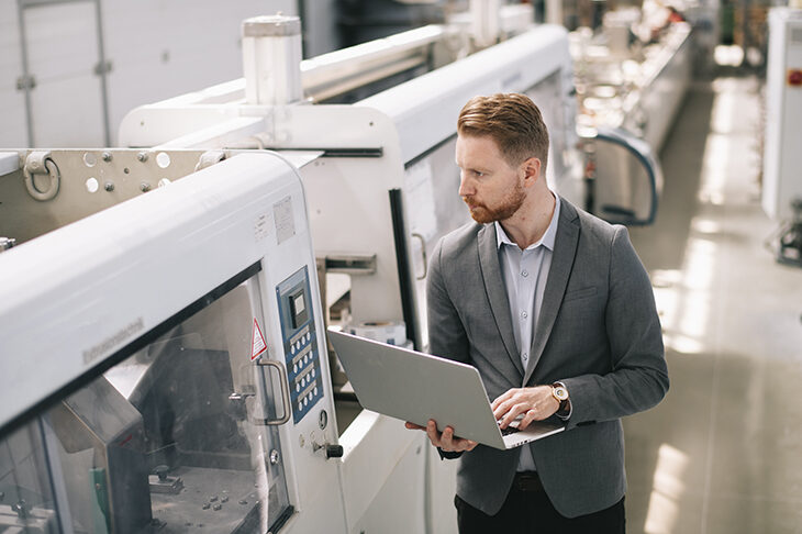 young employee inspecting machines