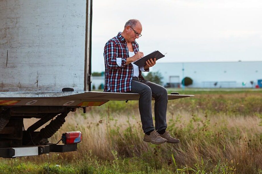 man sitting on the back of a van