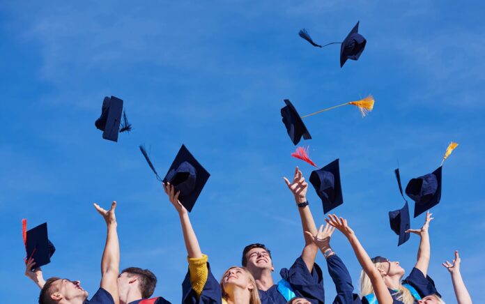Students throwing grad caps in the air