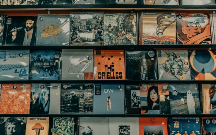 A mid height shot of some shelves in a record store, featuring many records