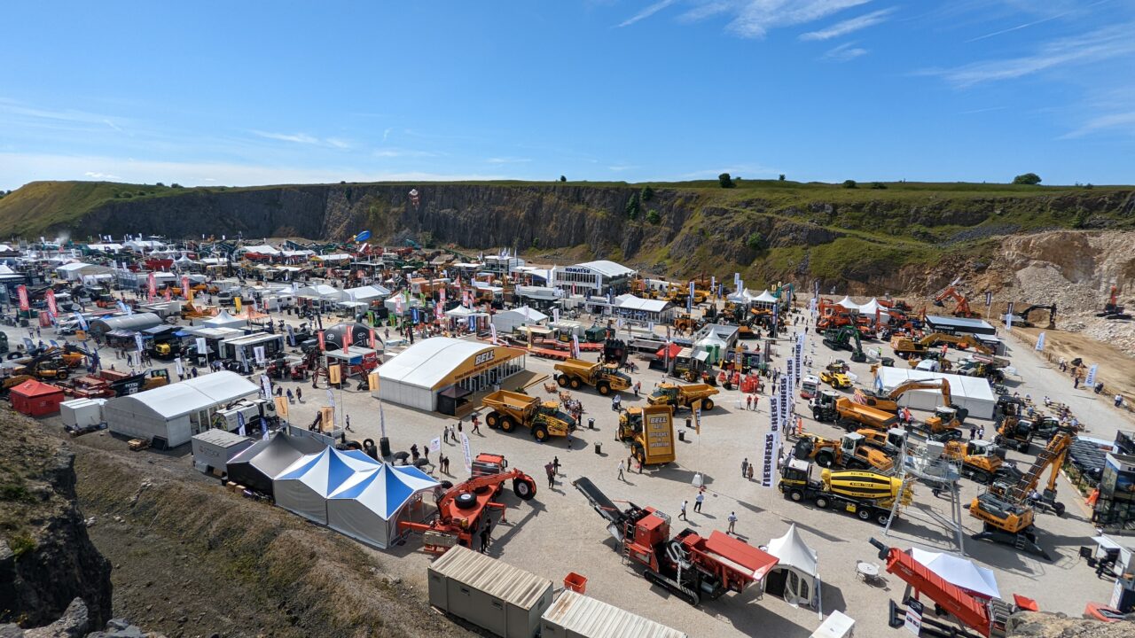 A wide shot photograph of an outdoor exhibition of engineering and farming vehicles