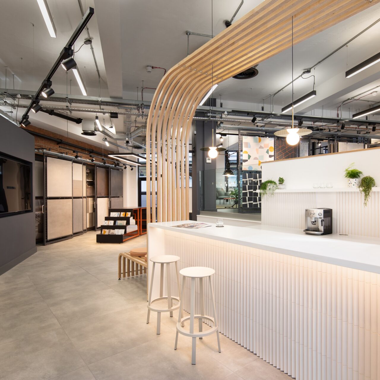 An interior shot of a building, with a coffee bar and flooring samples on the walls.