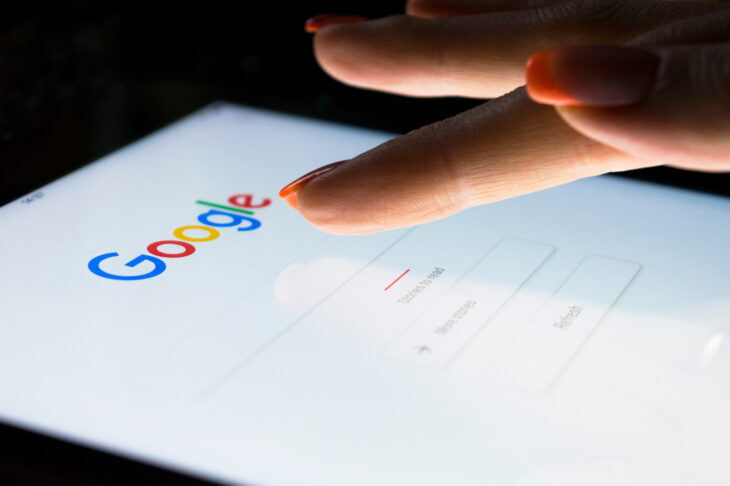 A womans hand on a tablet