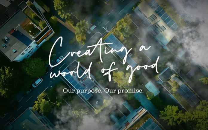 Creating a world of good slogan with buildings and forestry in the background