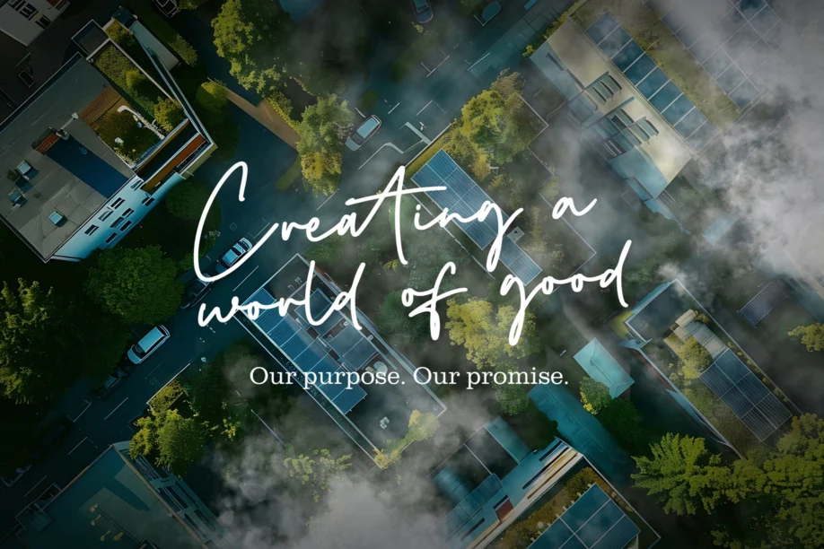Creating a world of good slogan with buildings and forestry in the background