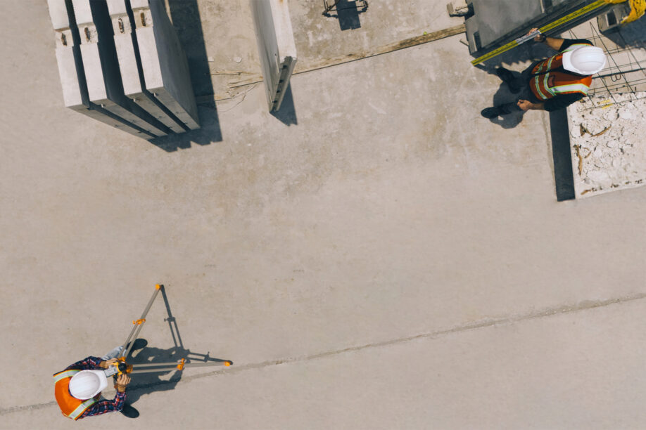 Worker filming worker with high vis jacket and safety helmet