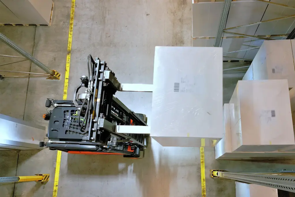 Fork lift lifting box in warehouse